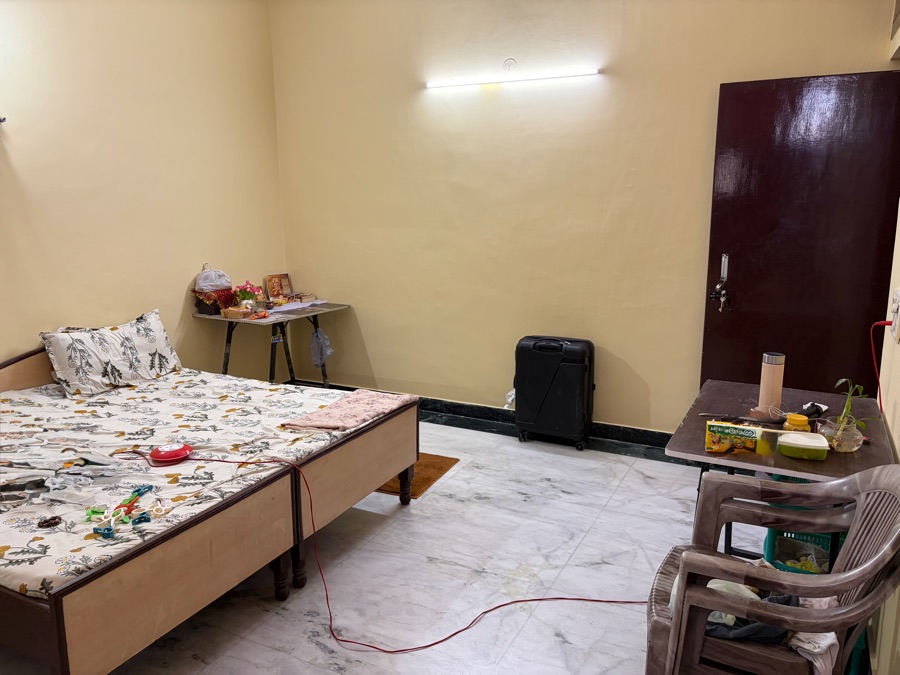 Spacious room with bed and cooler