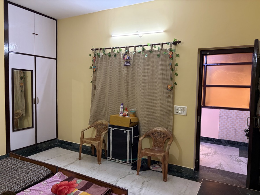 Room with wardrobe, chairs and attached bathroom